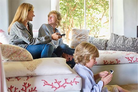 remote cellphone - Children and mother using electronic gadgets at home Stock Photo - Premium Royalty-Free, Code: 6108-05870414