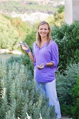 simsearch:6108-05872602,k - Portrait of a young woman gardening Stock Photo - Premium Royalty-Free, Code: 6108-05870543