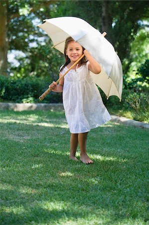 Cute little girl holding an umbrella Stock Photo - Premium Royalty-Free, Code: 6108-05870566