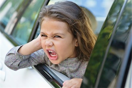 Cute little girl looking out of the car window Stock Photo - Premium Royalty-Free, Code: 6108-05870598