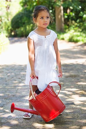 simsearch:6108-05870464,k - Cute little girl holding a watering can Stock Photo - Premium Royalty-Free, Code: 6108-05870524