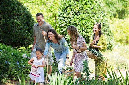 senior man in rubber boots - Happy multi generation family enjoying in the garden Stock Photo - Premium Royalty-Free, Code: 6108-05870693