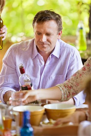 simsearch:6102-03828319,k - Mature man looking at a wine bottle Stock Photo - Premium Royalty-Free, Code: 6108-05870626