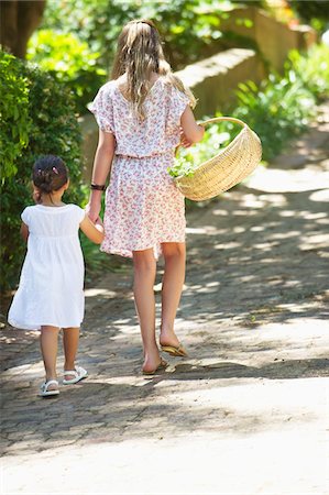 flower garden child - Rear view of siblings walking holding hands in garden Stock Photo - Premium Royalty-Free, Code: 6108-05870719
