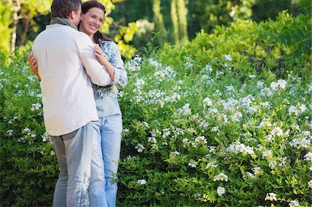 Happy mature couple romancing in a garden Stock Photo - Premium Royalty-Free, Code: 6108-05870731