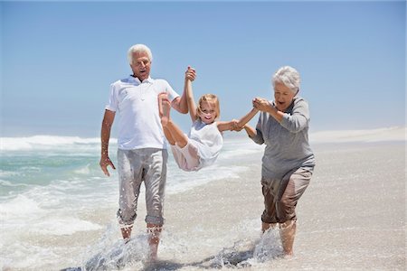 playing in water - Girl enjoying on the beach with her grandparents Stock Photo - Premium Royalty-Free, Code: 6108-05870843