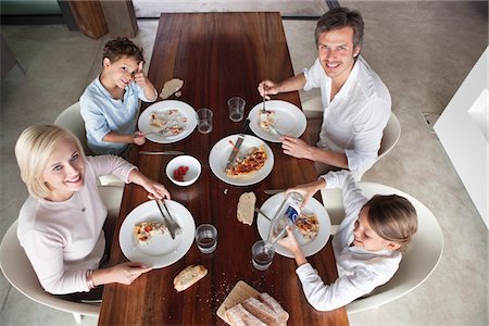 dining table plates dinner - Family having food together Stock Photo - Premium Royalty-Free, Code: 6108-05871188