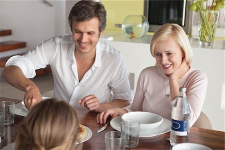 enjoying dinner with family - Couple having food with their daughter Stock Photo - Premium Royalty-Free, Code: 6108-05871190