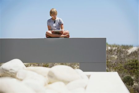 patio stones - Teenage boy using a digital tablet Stock Photo - Premium Royalty-Free, Code: 6108-05871104