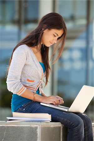 student with computer in campus - Young woman using a laptop Stock Photo - Premium Royalty-Free, Code: 6108-05871347