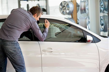 side mirror - Mid adult man looking at car for buying Stock Photo - Premium Royalty-Free, Code: 6108-05871382