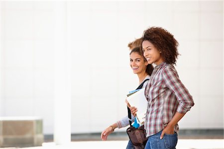 Two female friends walking in campus Stock Photo - Premium Royalty-Free, Code: 6108-05871309