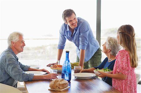 quattro generazioni - Multi generation family eating food at a dining table Fotografie stock - Premium Royalty-Free, Codice: 6108-05871501