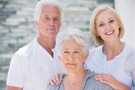 senior couple eye contact head and shoulders not indoors - Young woman smiling with her parents Stock Photo - Premium Royalty-Free, Code: 6108-05871515