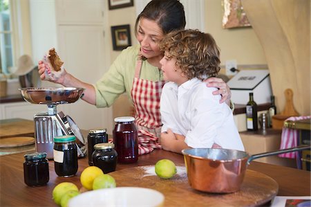 simsearch:6108-06907097,k - Grandmother and little boy cooking food at kitchen Stock Photo - Premium Royalty-Free, Code: 6108-05871767