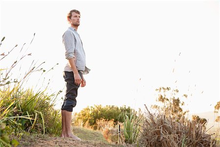 simsearch:6108-06905197,k - Man standing on a trail and looking serious Stock Photo - Premium Royalty-Free, Code: 6108-05871867