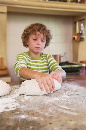 simsearch:6108-06907111,k - Cute little boy kneading dough at kitchen Stock Photo - Premium Royalty-Free, Code: 6108-05871820