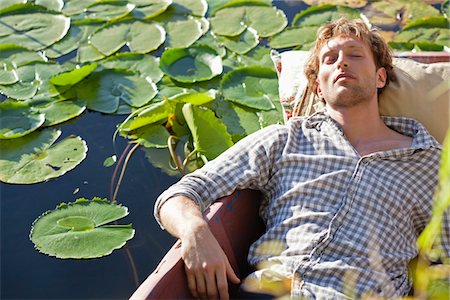 pillow - Young man sleeping in the boat Stock Photo - Premium Royalty-Free, Code: 6108-05871837