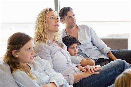 family tv indoors - Family with three children sitting on a couch Stock Photo - Premium Royalty-Free, Code: 6108-05872087