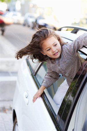Cute little girl looking out of the car window Stock Photo - Premium Royalty-Free, Code: 6108-05872192