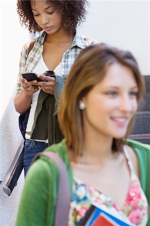 simsearch:6108-05869877,k - Close-up of a university student with African American woman using mobile phone in the background Foto de stock - Sin royalties Premium, Código: 6108-05872295