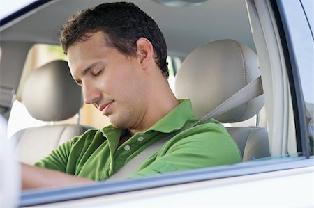 sleeping by the window - Mid adult man sleeping while driving a car Stock Photo - Premium Royalty-Free, Code: 6108-05872213