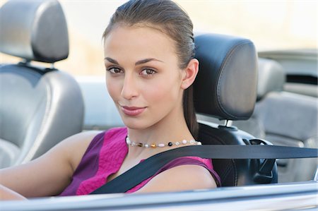 profile face person close up outdoors - Portrait of a beautiful young woman driving a convertible car Stock Photo - Premium Royalty-Free, Code: 6108-05872212