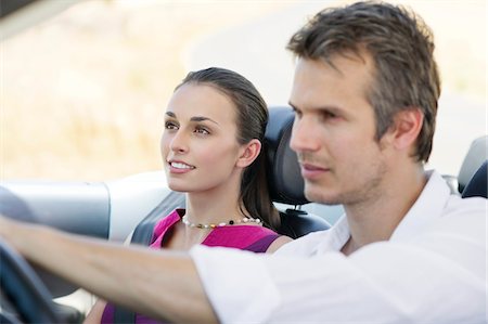 Couple driving a convertible car Stock Photo - Premium Royalty-Free, Code: 6108-05872234