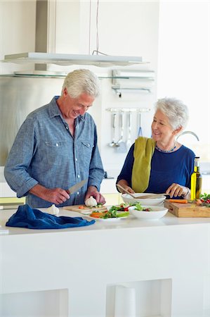 simsearch:6108-05871799,k - Senior couple preparing food at a domestic kitchen Stock Photo - Premium Royalty-Free, Code: 6108-05872343