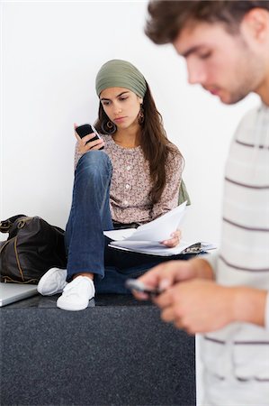 simsearch:6108-05871344,k - Two young people using mobile phones Stock Photo - Premium Royalty-Free, Code: 6108-05872340