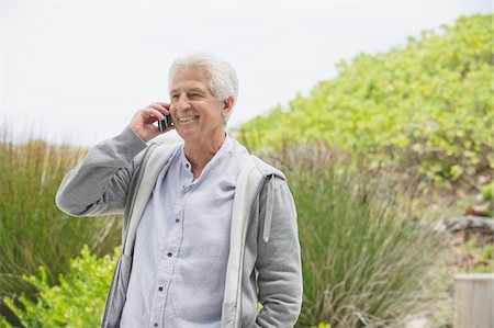 person standing mobile beach - Senior man talking on a mobile phone Stock Photo - Premium Royalty-Free, Code: 6108-05872359