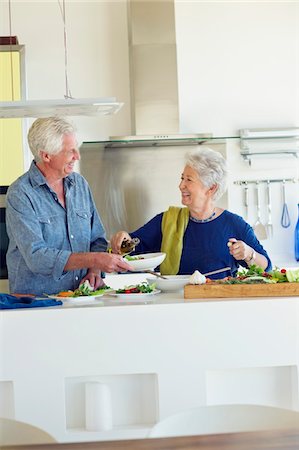 simsearch:6108-05871799,k - Senior couple preparing food at a domestic kitchen Stock Photo - Premium Royalty-Free, Code: 6108-05872416