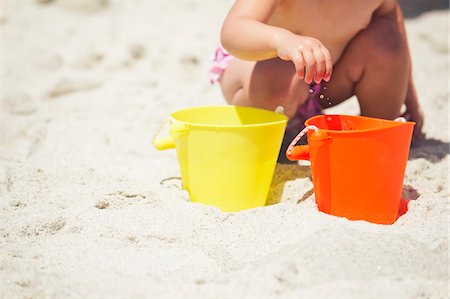 dig sand - Low section view of a girl playing with sand on the beach Stock Photo - Premium Royalty-Free, Code: 6108-05872557