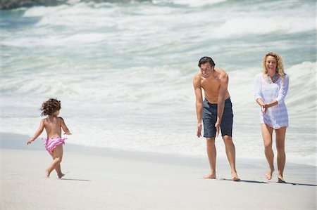 fun of the water - Happy family playing on the beach Stock Photo - Premium Royalty-Free, Code: 6108-05872510