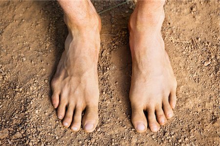 photography looking down at feet - Low section view of a barefooted man Stock Photo - Premium Royalty-Free, Code: 6108-05872646