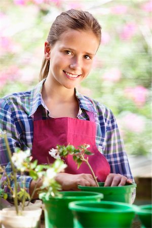 Portrait of a girl gardening and smiling Stock Photo - Premium Royalty-Free, Code: 6108-05872603