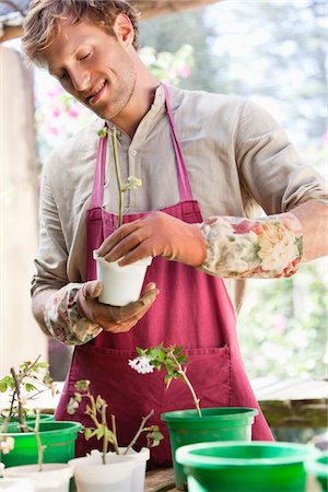 simsearch:6108-05869639,k - Man gardening and smiling Stock Photo - Premium Royalty-Free, Code: 6108-05872602