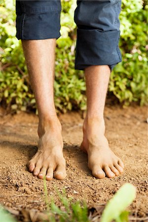 Low section view of a barefooted man Stock Photo - Premium Royalty-Free, Code: 6108-05872634