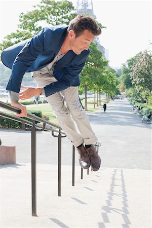 eiffel tower - Man jumping across handrail of steps, Eiffel Tower, Paris, Ile-de-France, France Stock Photo - Premium Royalty-Free, Code: 6108-05872894