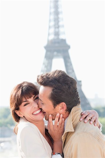 Couple kissing with the Eiffel Tower in the background, Paris, Ile-de-France, France Stock Photo - Premium Royalty-Free, Image code: 6108-05872975