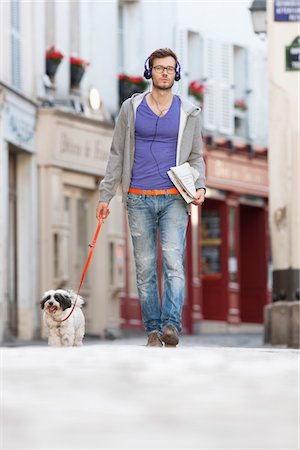 puppy people not humour not group not kitten - Man holding a dog on leash, Paris, Ile-de-France, France Stock Photo - Premium Royalty-Free, Code: 6108-05872994