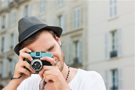 Man photographing with a camera, Paris, Ile-de-France, France Stock Photo - Premium Royalty-Free, Code: 6108-05873049