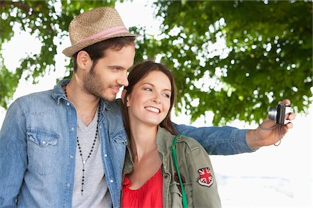 Couple taking a picture of themselves with a digital camera, Paris, Ile-de-France, France Stock Photo - Premium Royalty-Free, Code: 6108-05873257