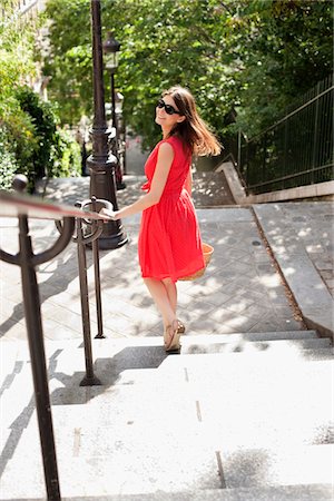 red sunglasses - Woman moving down staircases and smiling, Montmartre, Paris, Ile-de-France, France Stock Photo - Premium Royalty-Free, Code: 6108-05873265