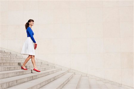full length - Woman moving down steps, Paris, Ile-de-France, France Stock Photo - Premium Royalty-Free, Code: 6108-05873266