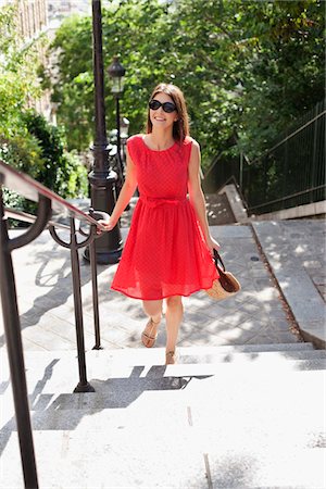 stair railings europe image - Woman moving up staircases, Montmartre, Paris, Ile-de-France, France Stock Photo - Premium Royalty-Free, Code: 6108-05873297