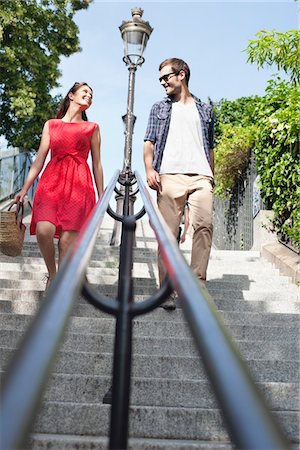 stair railings europe image - Couple moving down staircases, Montmartre, Paris, Ile-de-France, France Stock Photo - Premium Royalty-Free, Code: 6108-05873210