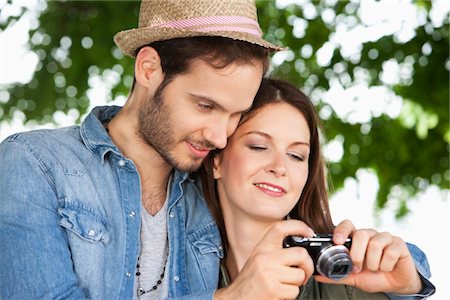 Couple watching photos in a digital camera, Paris, Ile-de-France, France Stock Photo - Premium Royalty-Free, Code: 6108-05873236