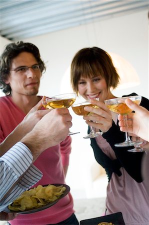 2 couples clinking glasses of champagne Stock Photo - Premium Royalty-Free, Code: 6108-05873378