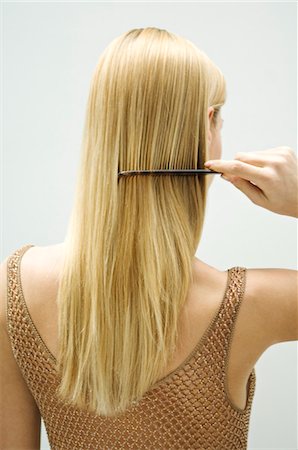 simsearch:6108-05855781,k - Blond woman combing her hair Stock Photo - Premium Royalty-Free, Code: 6108-05873486